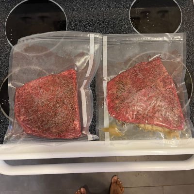 Vacuum sealed brisket. One of the bags has added smoked tallow.